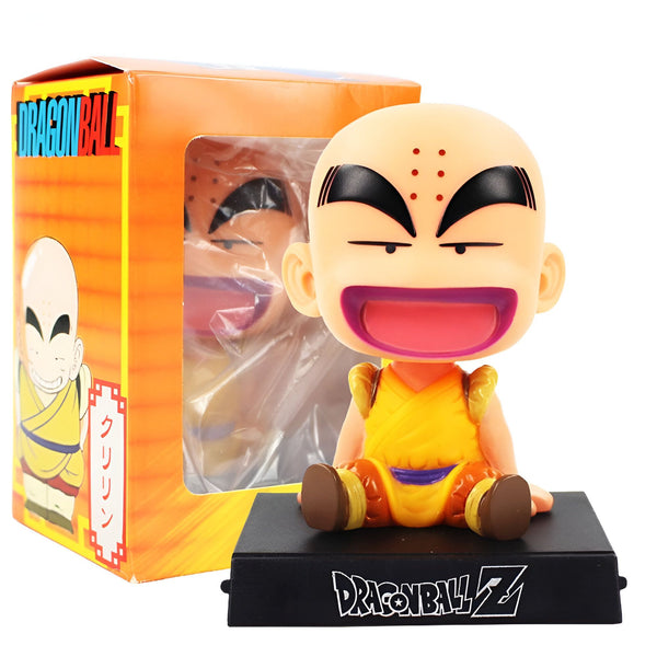 Une figurine de Krilin, un personnage de Dragon Ball Z. Il est chauve, porte un kimono orange et a une expression faciale joyeuse. Il est assis sur un socle noir et est emballé dans une boîte orange avec une fenêtre transparente.,BO-5017708057