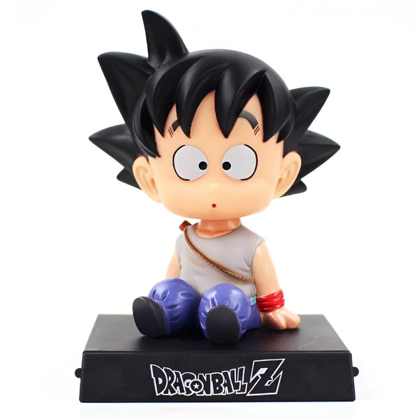 Une figurine de Son Goku, un personnage de Dragon Ball Z, est assise sur un socle noir. Il porte une expression surprise sur son visage.,BO-1118965817