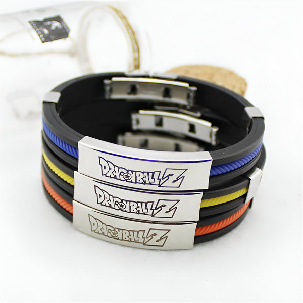 Trois bracelets Dragon Ball Z en silicone noir, jaune et bleu. Les bracelets sont décorés du logo Dragon Ball Z en métal.,BR-4324648573,BR-7258262997,BR-0099893509