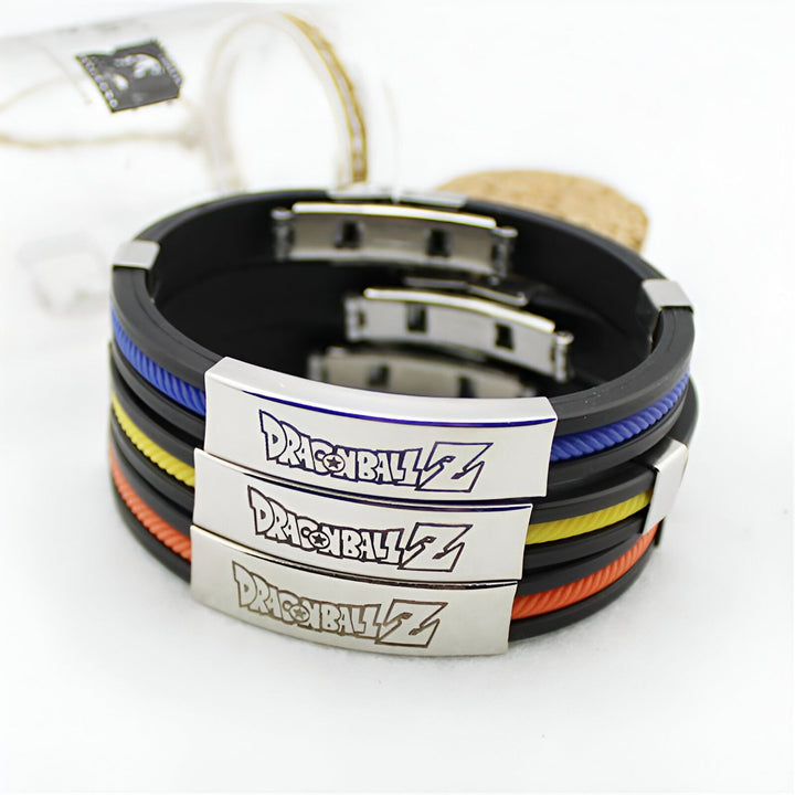 Trois bracelets Dragon Ball Z en silicone noir, jaune et bleu. Les bracelets sont décorés du logo Dragon Ball Z en métal.,BR-4324648573,BR-7258262997,BR-0099893509