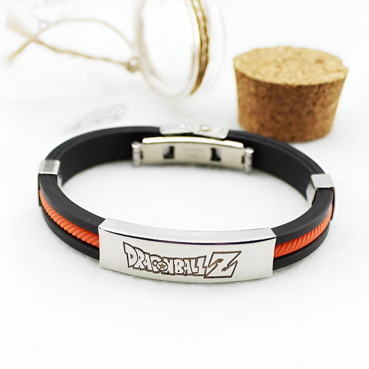 Un bracelet en silicone noir et orange avec une plaque en métal上有文字“DRAGON BALL Z”.,BR-4324648573,BR-7258262997,BR-0099893509