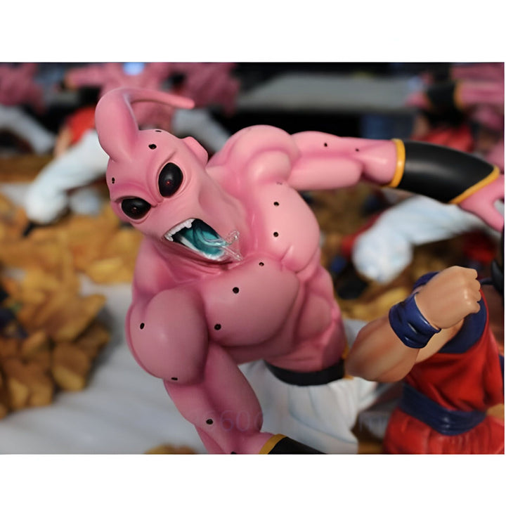 Une figurine de Buu, un personnage de Dragon Ball Z, en train de combattre. Buu est un personnage rose avec des yeux noirs et une grande bouche. Il est très musclé et a une longue langue. Il est en train de combattre un autre personnage, qui est vêtu de bleu et de jaune. Le fond de l'image est orange et marron.,FI-9119597312