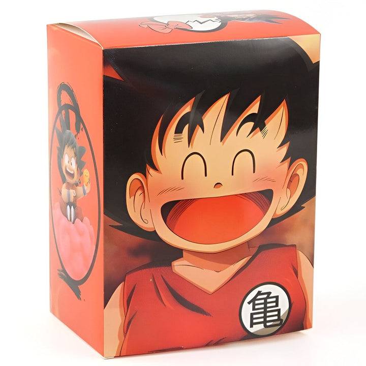 Une figurine de Son Goku, un personnage de Dragon Ball Z, dans sa combinaison orange avec le kanji "Tortue" dans le dos. Il est souriant et tient une boule de cristal à la main. La figurine est dans une boîte en carton rouge et noir avec une illustration de Son Goku sur le devant.,FI-9809827229