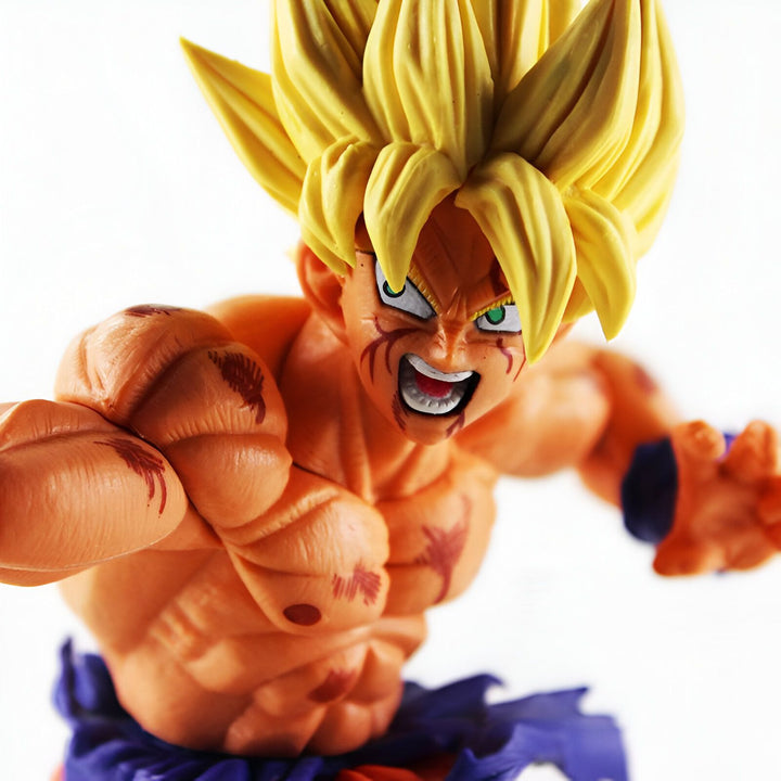 Une figurine de Son Goku, un personnage de la série animée Dragon Ball Z. Il est représenté avec les cheveux jaunes, les yeux verts et le corps musclé. Il porte un gi orange et bleu déchiré et est en position de combat.,FI-4265488455