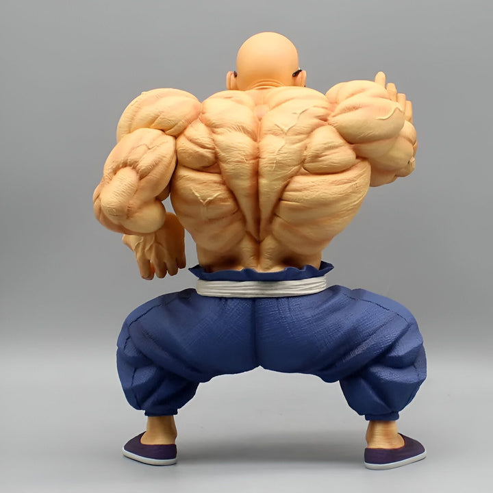 Une figurine de dos de Hercule Satan, un personnage de Dragon Ball Z. Il est chauve, musclé et porte un pantalon bleu et des chaussures violettes.,FI-2942176539