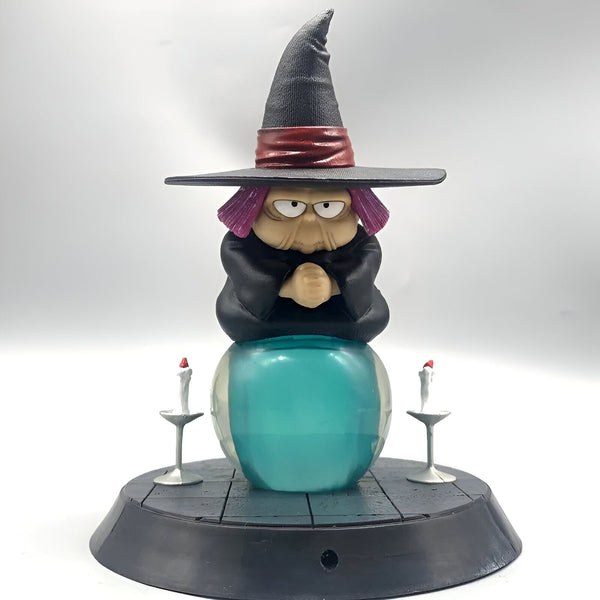 Une figurine de la sorcière Baba de la série Dragon Ball Z. Elle est représentée assise sur une boule de cristal, avec un chapeau pointu et une robe noire. Elle a les cheveux mauves et la peau verte.,FI-9279471627