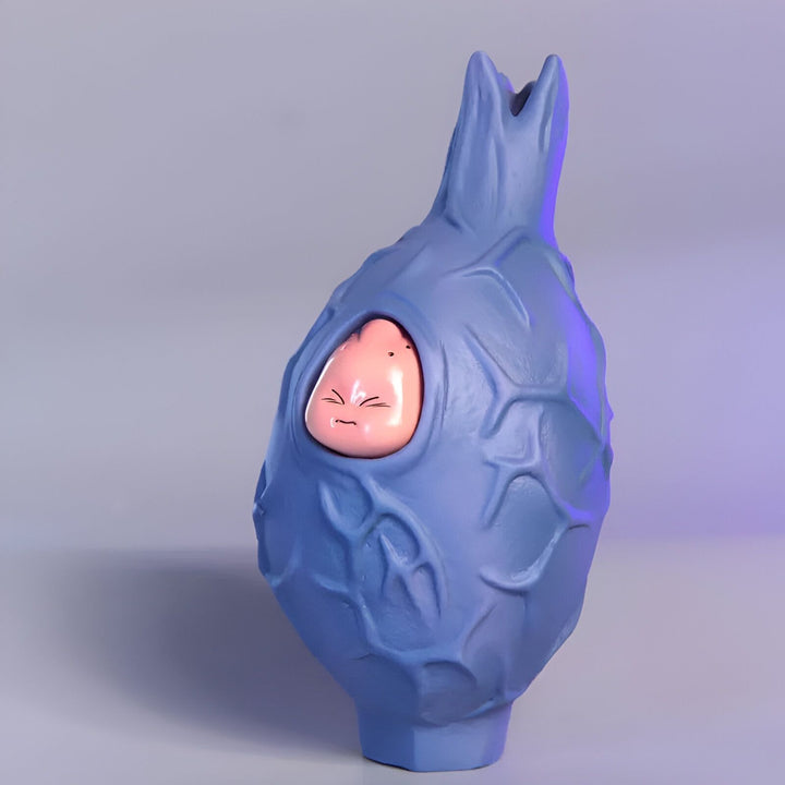 Une figurine de Buu dans sa chrysalide, un personnage de Dragon Ball Z. Buu est rose et la chrysalide est bleue.,FI-1577601327