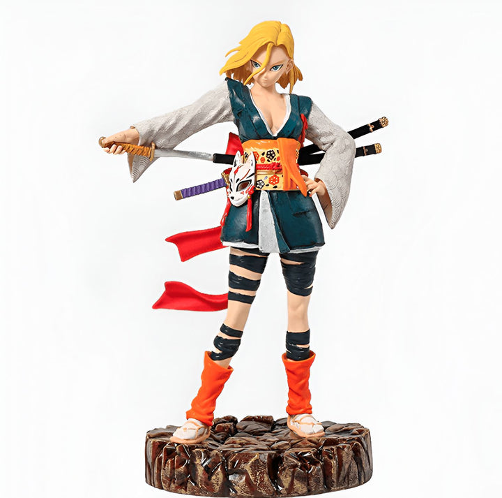 Une figurine d'Android 18, un personnage de la série Dragon Ball Z. Elle est représentée dans une tenue de samouraï, avec un kimono bleu et blanc, une obi rouge et des sandales. Elle tient deux sabres dans ses mains.,FI-5307074484