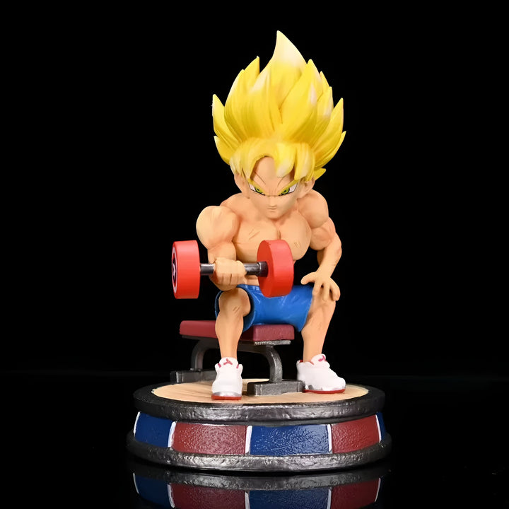 Une figurine de Son Goku, un personnage de Dragon Ball Z, en train de soulever des haltères. Il est assis sur un banc et porte un short bleu et des baskets blanches.,FI-9124101168