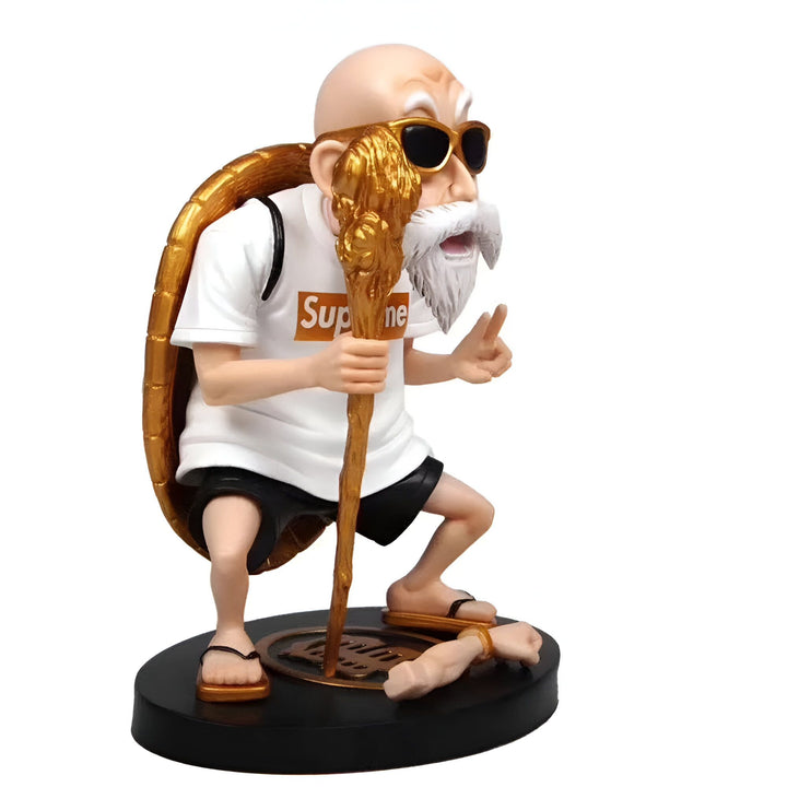 Une figurine en plastique de Master Roshi, un personnage de Dragon Ball Z. Il est vêtu d'un t-shirt blanc avec le logo Supreme, d'un short noir et de lunettes de soleil dorées. Il tient un bâton à la main et porte une tortue sur son dos. La figurine est posée sur un socle noir.,FI-4156141535