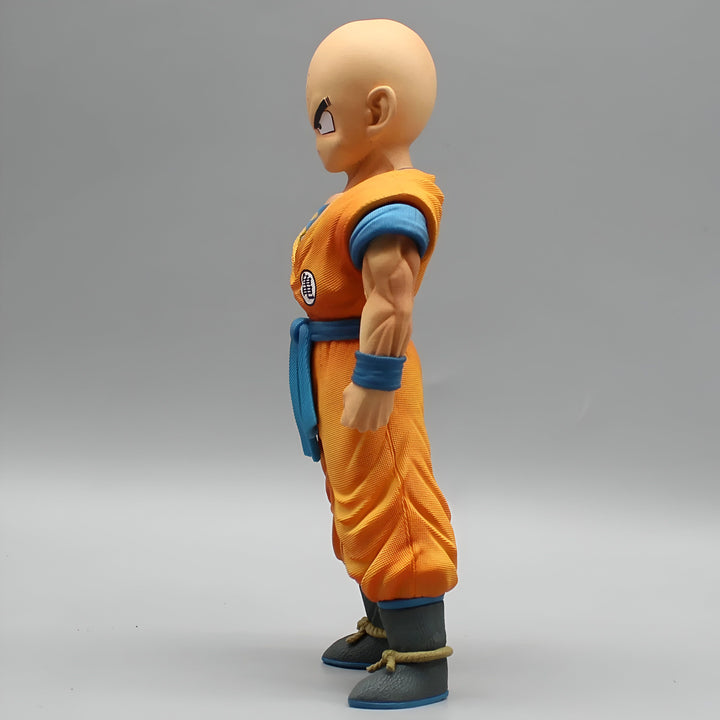 Une figurine de Krilin, un personnage de Dragon Ball Z. Il est chauve, porte une combinaison orange et une ceinture bleue. Il est représenté de profil.,FI-6069348427