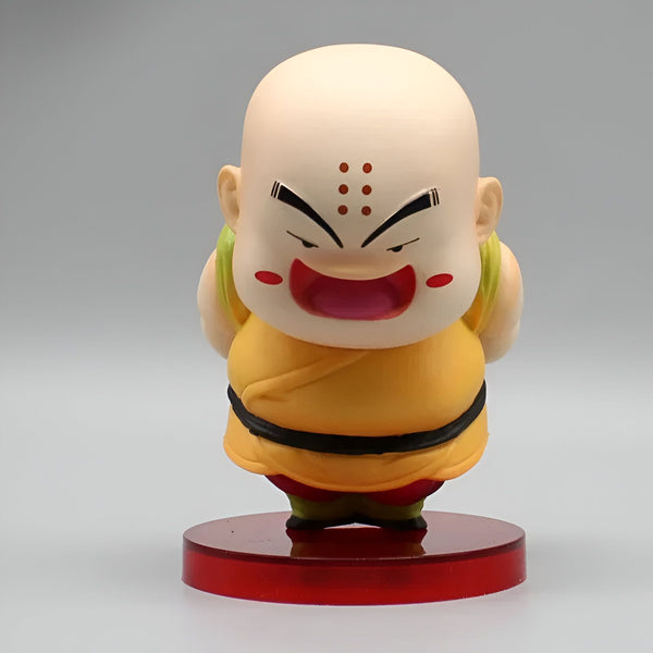 Une figurine de Krilin, un personnage de Dragon Ball Z. Il est chauve, a trois points sur le front, porte une tenue orange et une ceinture noire. Il est souriant et a les bras croisés.,FI-2822054479