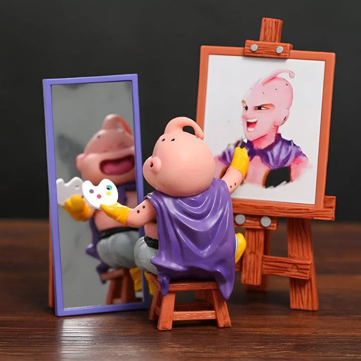 Une figurine de Buu de Dragon Ball Z en train de peindre un tableau de lui-même. Il est assis sur un tabouret devant un chevalet. Il porte une cape violette et une palette de peinture à la main. Il regarde son reflet dans un miroir.,FI-6393990864