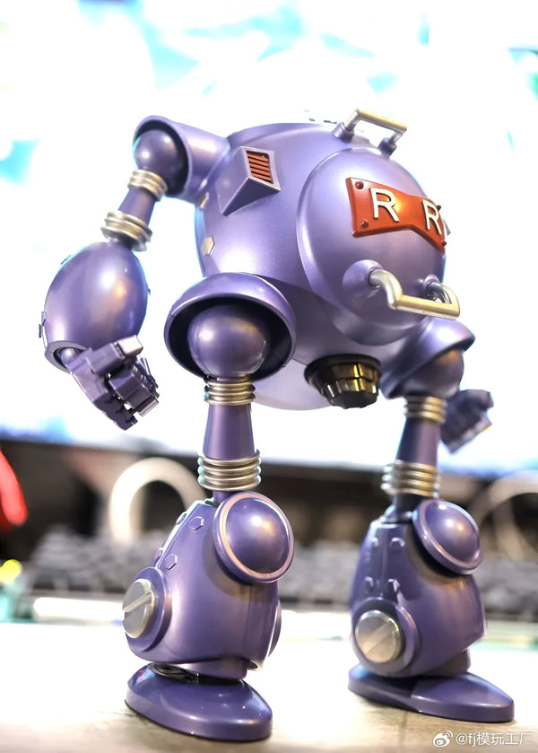 L'image montre un robot violet avec une tête ronde et des bras et des jambes épais. Il a un grand "R" rouge sur la poitrine. Le robot est posé sur une surface blanche.,FI-6968650274