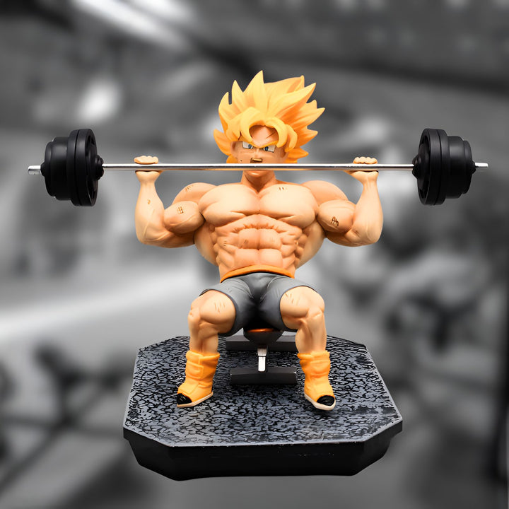 Une figurine de Son Goku en train de soulever des poids. Il est assis sur un banc et porte une tenue de sport orange et bleue. Il a les cheveux jaunes et les yeux bleus. La figurine est détaillée et mesure environ 20 cm de haut.,FI-8071709026