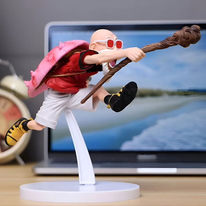 Une figurine de Tortue Géniale, un personnage de Dragon Ball, en train de voler. Il porte une carapace de tortue rose sur le dos, une chemise rouge, un pantalon blanc et des chaussures jaunes. Il a une barbe blanche et des lunettes de soleil rouges. Il tient un bâton marron dans sa main droite.,FI-7127817340