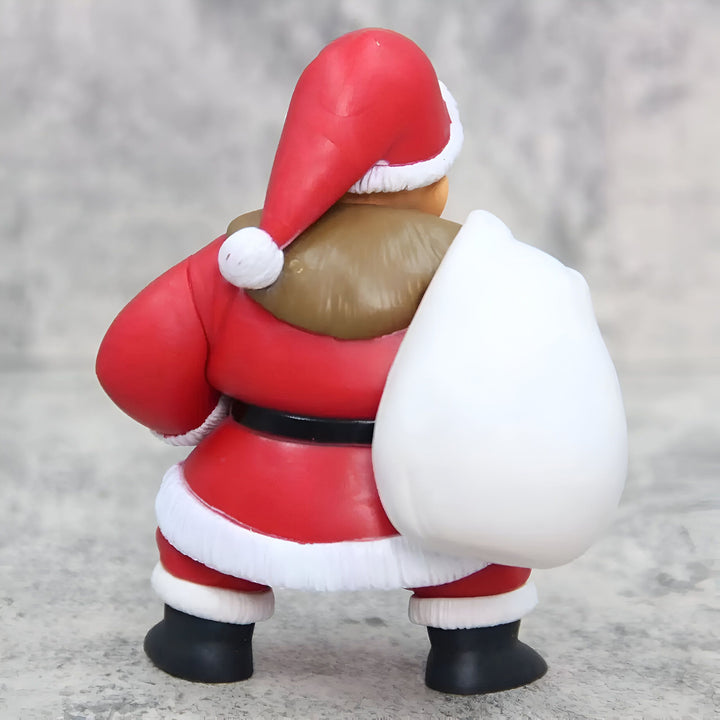 Une figurine du Père Noël en plastique rouge et blanc, avec un sac blanc sur le dos.,FI-5075916473