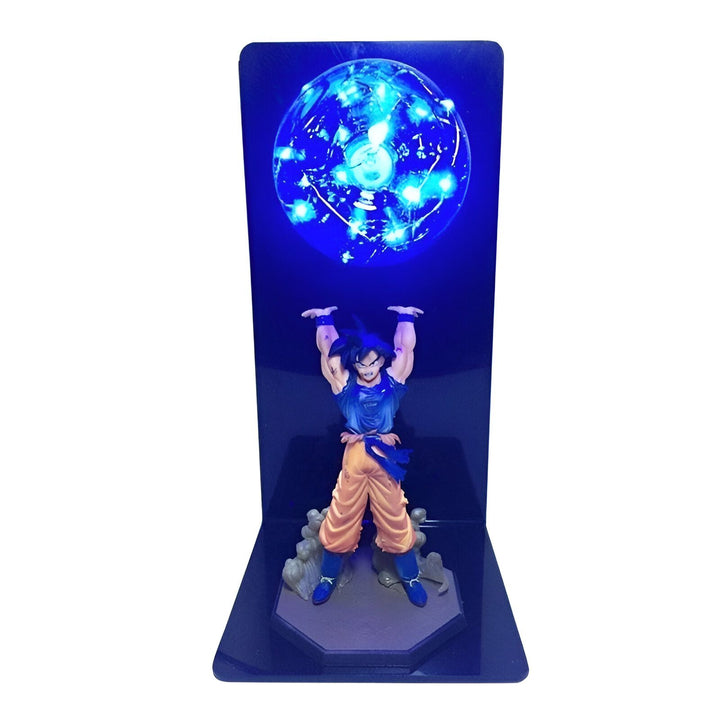 Une figurine de Son Goku, un personnage de Dragon Ball Z, en train de charger un Genkidama. La figurine est éclairée par une lumière bleue.,FI-8250584058