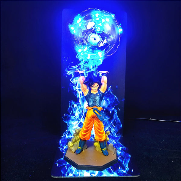 Une figurine de Son Goku, un personnage de Dragon Ball Z, est en train de charger un Genkidama. La figurine est éclairée par une lumière bleue.,LA-6692318254