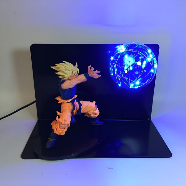 Une figurine de Son Goku en train de lancer un Kamehameha. La figurine est éclairée par une lumière bleue.,LA-6245030056