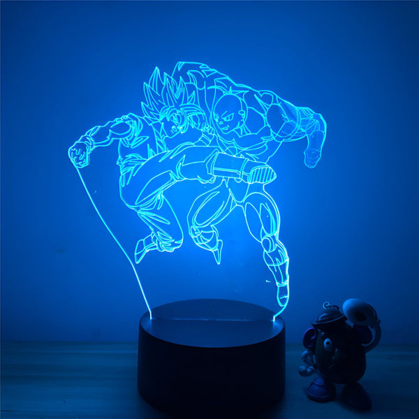 Une image de Son Goku et Vegeta, deux personnages de la série animée Dragon Ball Z, en train de se battre. Son Goku est en train de donner un coup de pied à Vegeta. L'image est éclairée par une lumière bleue.,LA-5390847075