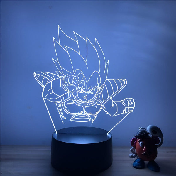 Une image d'un personnage de dessin animé, Vegeta, de la série Dragon Ball Z. Il est représenté en train de se battre, avec un poing en l'air et l'autre poing fermé. Il est entouré d'un halo de lumière bleue.,LA-7346583477