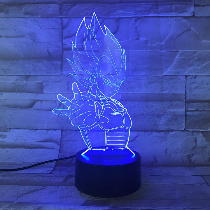 Une image d'une figurine de Vegeta, un personnage de la série Dragon Ball Z. La figurine est éclairée par une lumière bleue et est posée sur un socle noir.,LA-9800412301