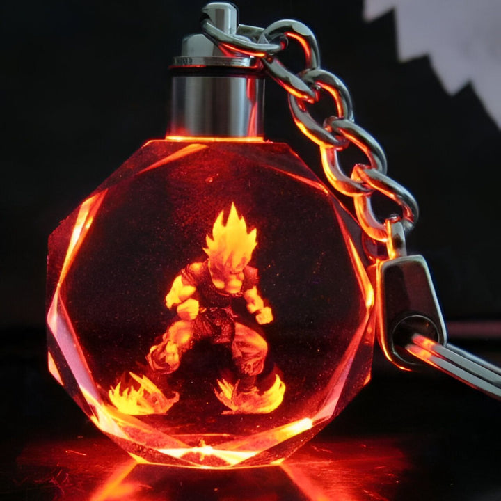 Un porte-clés en cristal avec une figurine de Son Goku, un personnage de la série animée Dragon Ball Z. La figurine est éclairée par une lumière rouge.,PO-5198107344