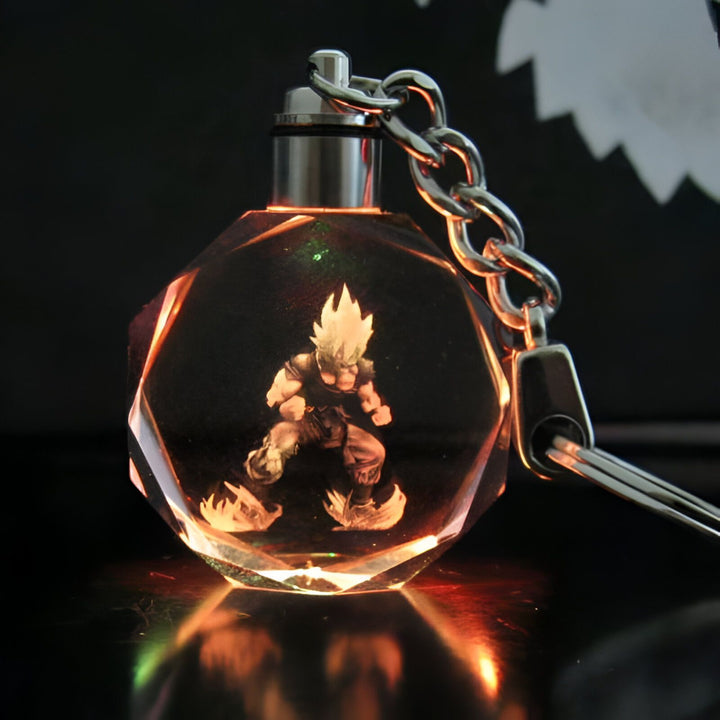 Un porte-clés en cristal avec une figurine de Son Goku, un personnage de la série animée Dragon Ball Z. La figurine est éclairée par une lumière LED qui change de couleur.,PO-5198107344