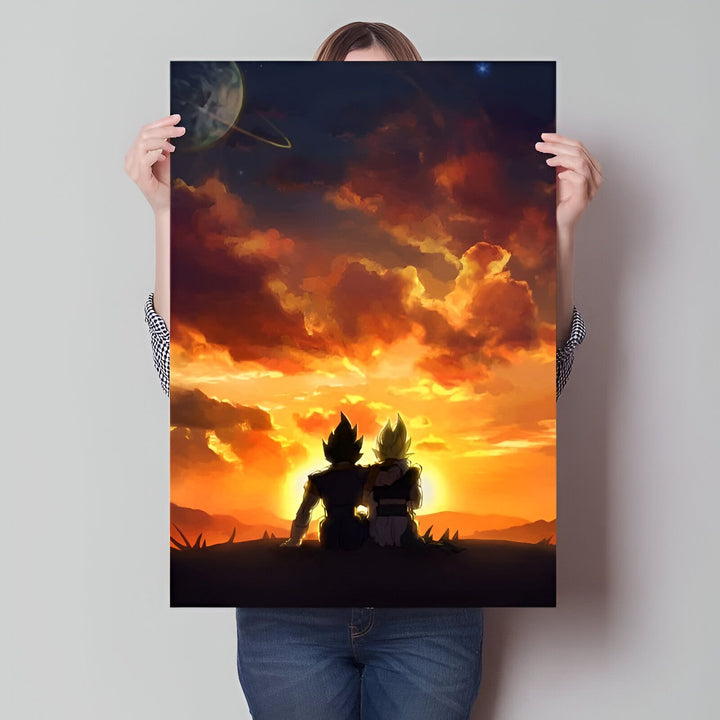 L'image montre deux personnages de dessins animés, Goku et Vegeta, assis sur une colline et regardant le coucher du soleil. Le ciel est orange et jaune, et les nuages sont roses et violets. Il y a une planète et une étoile dans le ciel.,PO-111912557X