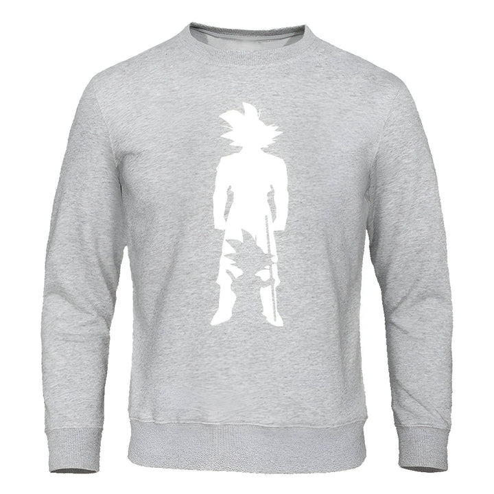 Le sweat-shirt gris représente Son Goku, un personnage de la série animée japonaise Dragon Ball Z. Il est vêtu de son costume de combat orange et bleu et tient son bâton magique à la main.