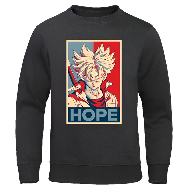 Le sweat-shirt noir représente le personnage de Trunks du manga Dragon Ball Z. Il est vêtu d'une veste bleue et d'un pantalon orange. Il a les cheveux bleus et les yeux bleus. Il est en position de combat, le poing droit en avant. Le texte "Hope" est écrit en rouge et bleu sur le côté droit du sweat-shirt.