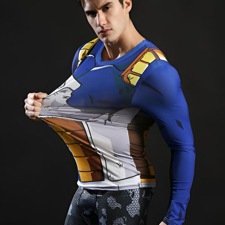 Un homme porte un t-shirt moulant bleu et jaune avec des manches longues. Le t-shirt représente le personnage de Vegeta, un personnage de la série animée Dragon Ball Z.,T--2801481661,T--7086463302,T--5635298281,T--574353702X,T--7745914949,T--6839783294,T--9494316304