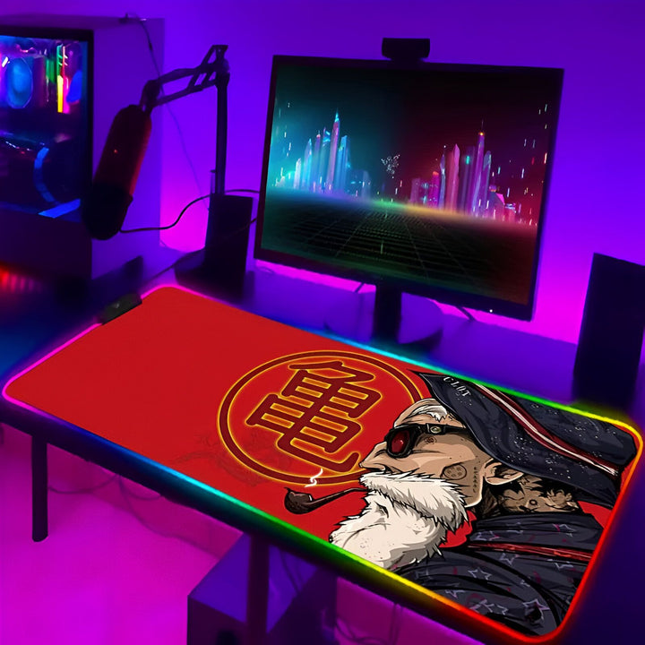 L'image représente un tapis de souris de couleur rouge avec le logo de Tortue Géniale de Dragon Ball Z en son centre. Le tapis de souris est éclairé par des lumières LED de couleur rouge, verte et bleue.,TA-6562800552,TA-6146165026,TA-3101633362