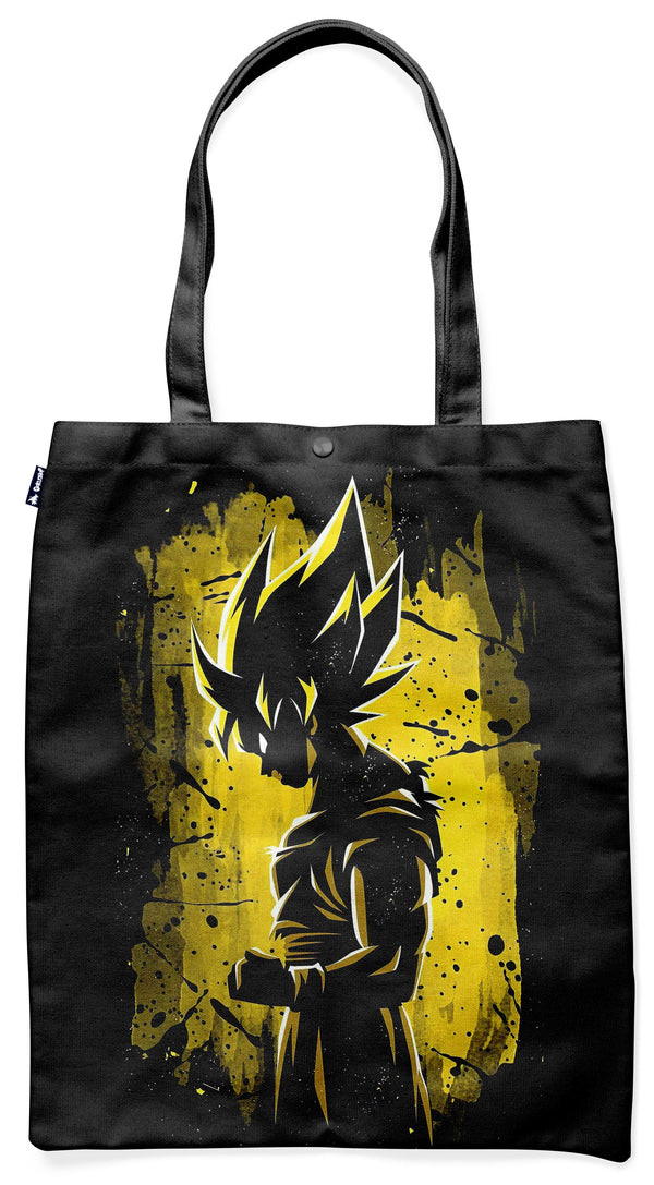 L'image représente un sac fourre-tout noir avec une illustration de Son Goku, un personnage de la série animée Dragon Ball Z. Son Goku est représenté de profil, avec ses cheveux hérissés et sa combinaison orange et bleue. Le sac est également décoré de taches de peinture jaune.,TO-0543182746