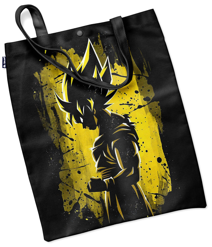 Le tote bag noir présente une illustration de Son Goku, un personnage de la série animée japonaise Dragon Ball Z. Il est représenté de dos, avec ses cheveux hérissés et sa combinaison orange et bleue. Le fond est jaune et noir.,TO-0543182746