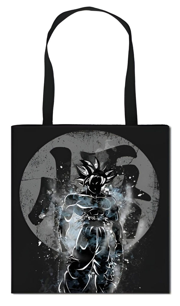 Le tote bag représente Son Goku, un personnage de la série animée Dragon Ball Z. Il est vêtu de son costume de combat et est en position de combat. Le fond est noir et le dessin est blanc et gris.,TO-0309277973
