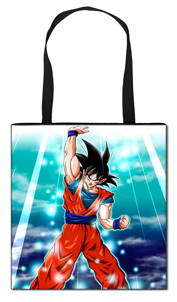 Un sac fourre-tout en toile de coton avec une image de Son Goku, un personnage de la série animée Dragon Ball Z. Son Goku est représenté en train de se tenir debout, le poing droit levé en l'air. Il porte une combinaison orange et bleue et une ceinture bleue. Le sac a des anses noires et une doublure intérieure.,TO-6390904479